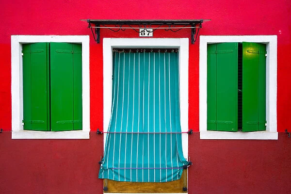 Italy, Burano. Colorful house windows and walls