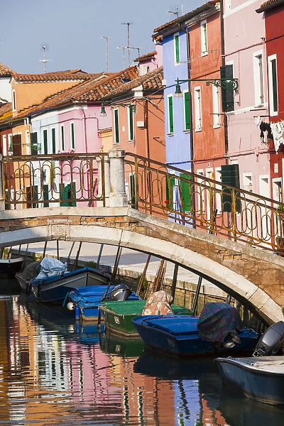 Italy, Burano. Reflection of colorful houses in canal