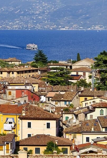 Italy, Lake Garda. A ferry on Lake Garda approaches the village of Limone