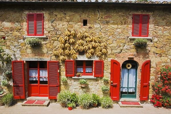 Italy, Lucignano, Red Shutters and Harvest Corn on House Lucignano