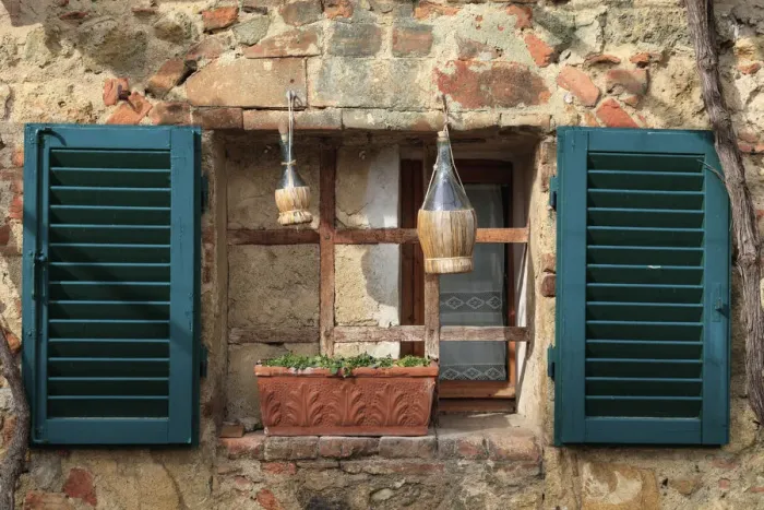 Framed Print : Italy, Monteriggioni. Stone wall, curtained window with blue shutters