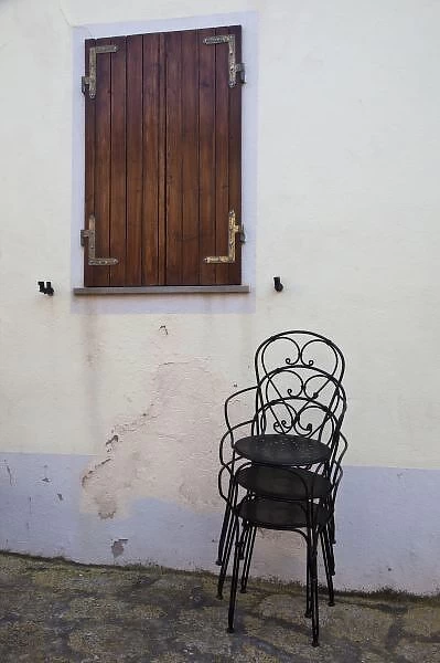 Italy, Sardinia, Castelsardo. Cafe chairs