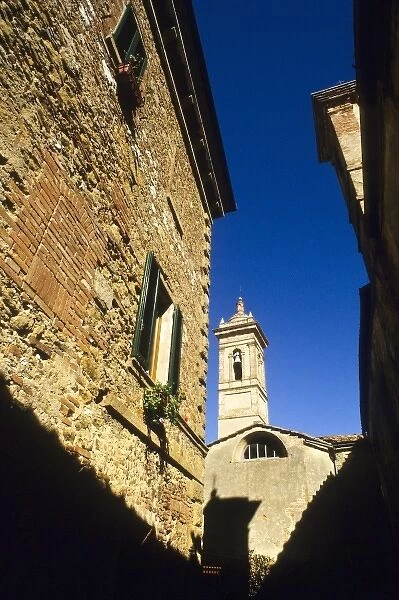 Italy: Tuscany, Castelmuzio, brick homes, windows with green shutters, with church