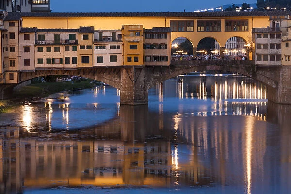 Italy, Tuscany, Florence, Ponte Vecchio reflected in Arno River at dusk