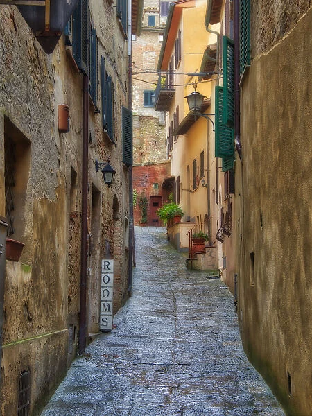 Italy, Tuscany. A narrow street scene in a village in Tuscany