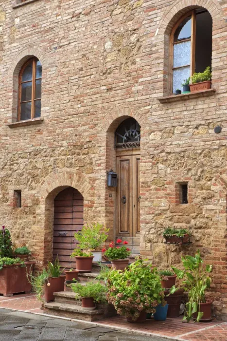 Framed Print : Italy, Tuscany, Pienza. Flower pots and potted plants decorate a narrow street in a Tuscany village