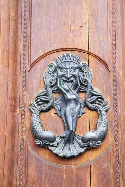 Italy, Tuscany, Pisa. Large antique door knocker on beautiful wooden door
