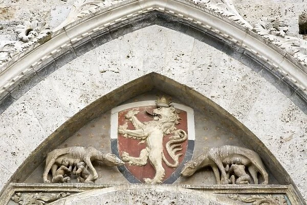 Italy, Tuscany, Sienna. Detail on Piazza del Campo showing a coat-of-arms and Romulus