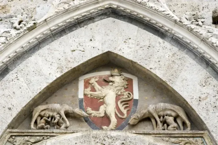 Framed Print : Italy, Tuscany, Sienna. Detail on Piazza del Campo showing a coat-of-arms and Romulus