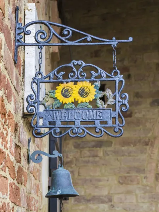 Framed Print : Italy, Tuscany. A wrought iron welcome sign in the village of Chiusure in the province of