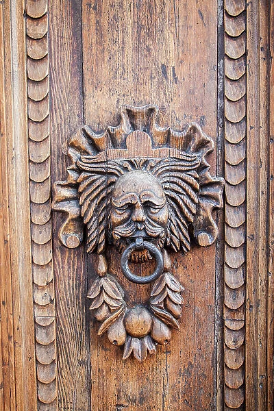 Italy, Umbria, Assisi. Ornate wood carved door knocker