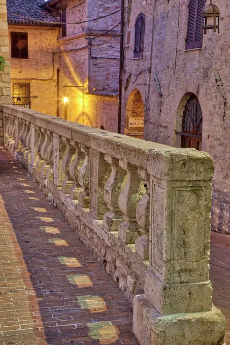 Framed Print : Italy, Umbria, Assisi. Short stone wall with columns near the Convento Chiesa Nuova