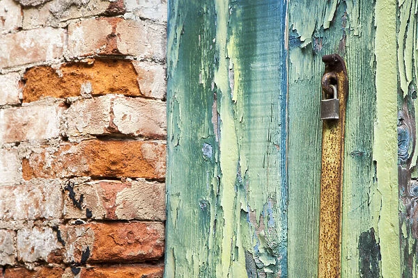 Italy, Venice, Burano Island. Patterns of peeling paint on old wooden doors