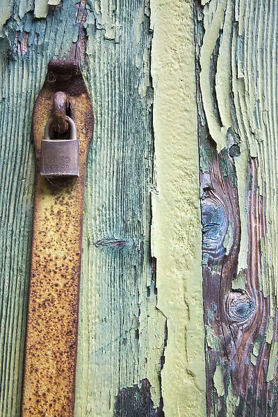 Italy, Venice, Burano Island. Patterns of peeling paint and padlock on old wooden doors