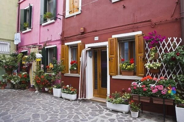 Italy, Venice, Burano. Multi-colored houses with flowers outside