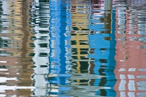 Italy, Venice, Burano. Multicolored houses reflected in water