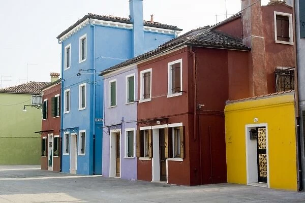Italy, Venice, Burano. A typical street lined with colorful houses