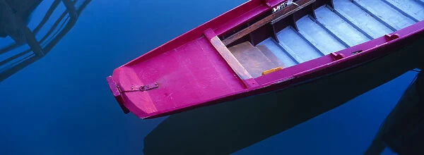 Italy, Venice. Colorful boat bow and reflection