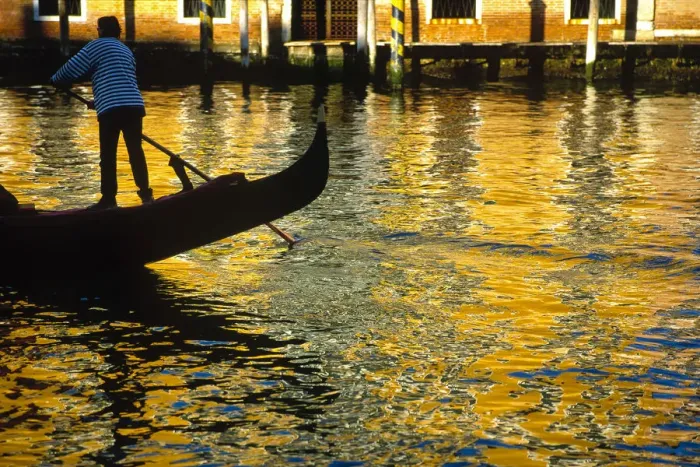 Framed Print : Italy, Venice. Gondolier steering gondola at sunset