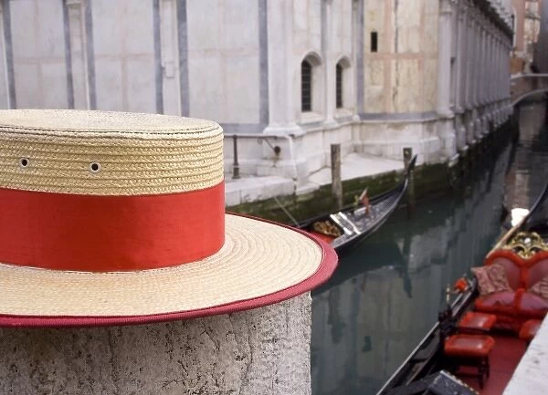 Italy, Venice. Detail of a gondoliers hat with the canal and gondolas in the background