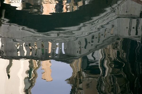 Italy, Venice. A reflection of a bridge on a canal