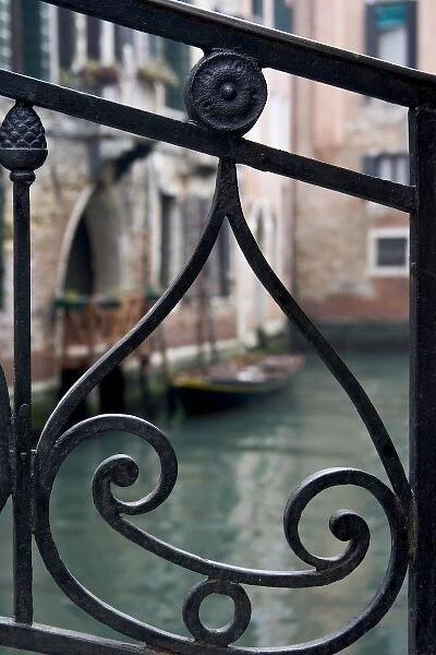 Italy, Venice. Stair railing metalwork design frames canal with gondola