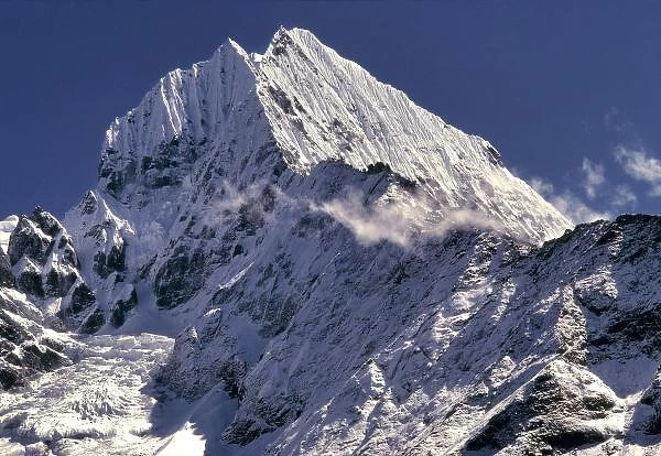 The jagged peaks of Tamserku, at 21, 680 ft. jut into the blue skies of the Khumbu
