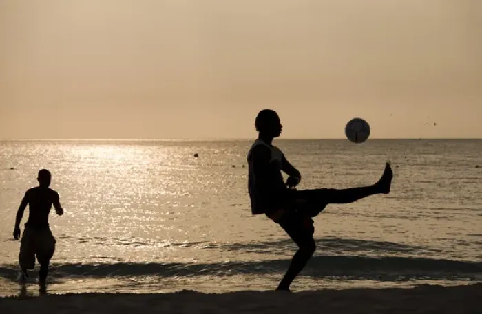 Framed Print : Jamaica, Negril, Silhouette of young men playing soccer along Caribbean Sea Framed Print : Jamaica, Negril, Silhouette of young men playing soccer along Caribbean Sea