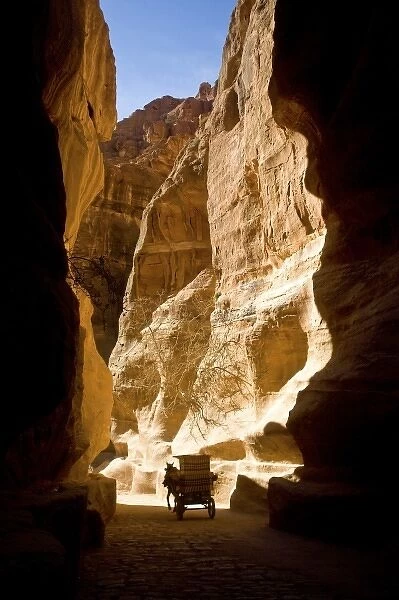 Jordan, Petra. A horse-drawn carriage in the Siq which leads to the fabled Hidden
