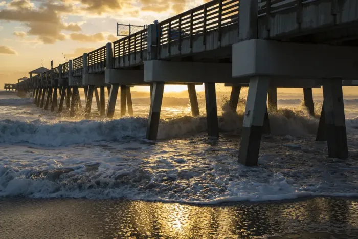 Framed Print : Juno Beach, Florida, Man watches high surf from the pier at Juno Beach