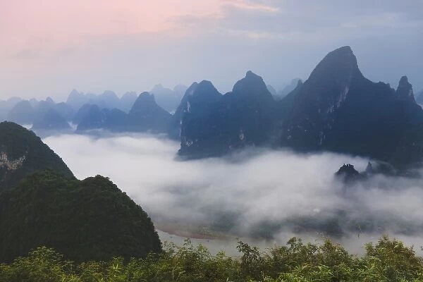 Karst hills in morning mist, Li River area, Yangshuo, Guangxi, China