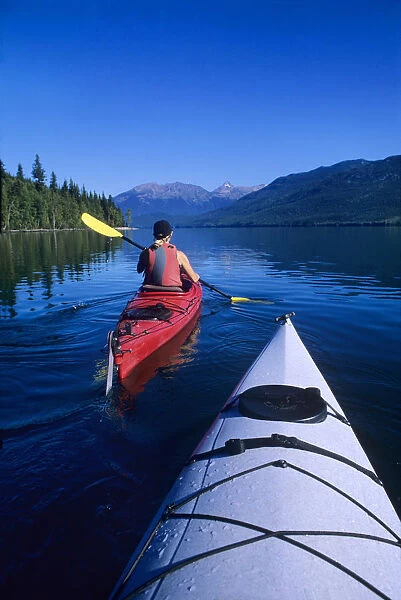 Kayaking on Clearwater Lake with Huntley Peak on the horizon in Wells Gray Provincial Park
