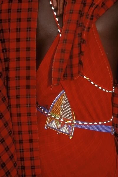 Kenya: Ambolseli National Park, back of Msai moran, dressed in traditional red plaid cloth