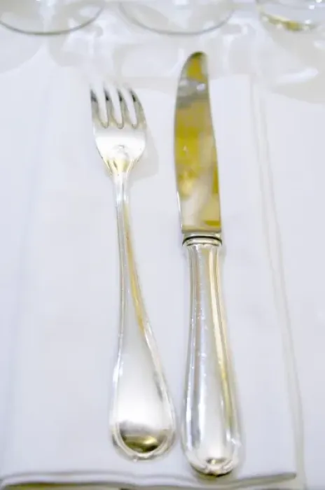 Framed Print : Knife and fork on a white linen napkin and table cloth in the restaurant Le Gourmandin