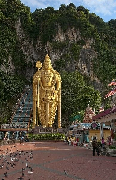 Kuala Lumpur, Malaysia. Batu Caves with gold statue of Lord Murugan at entrance