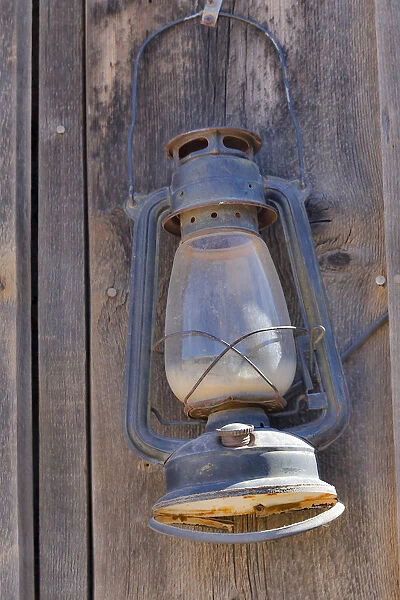 Lamp hanging on wooden wall