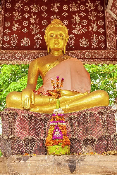 Laos, Luang Prabang. Golden Buddha statue and altar