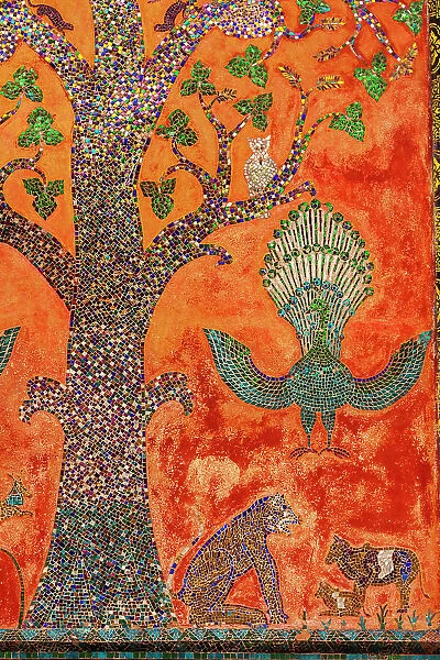 Laos, Luang Prabang. Mosaic depicting a tree, peacock, and other animals