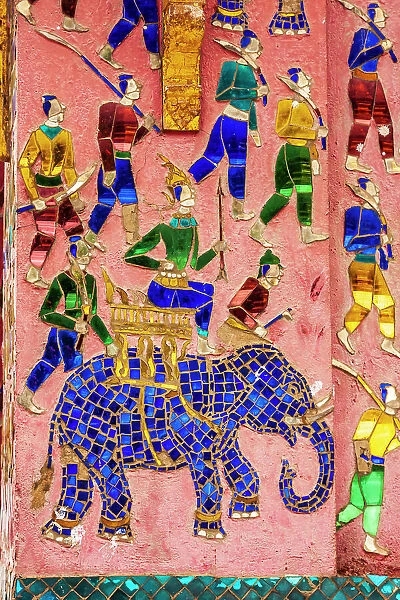 Laos, Luang Prabang. Mosaic mural depicting a man riding an elephant, preparing for hunting or battle