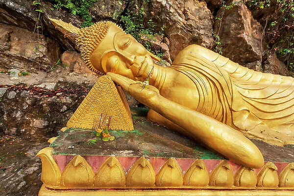 Laos, Luang Prabang. Reclining Buddha statue on Mount Phousi