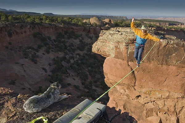 Larry Harpe highlining (slacklining) between Navaho Sandstone Towers with his dog watching