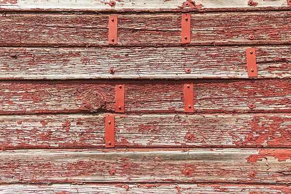 Latah, Washington State, USA. Peeling red paint on a weathered old barn