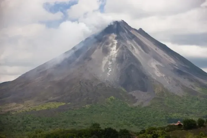 Framed Print : Lava rocks are thrown from the erupting Arenal volcano to the mountainside and forest