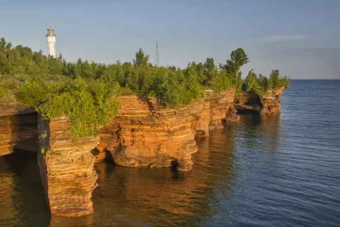 Framed Print : Layered sandstone cliffs and sea caves at sunrise on Devils Island Lighthouse in