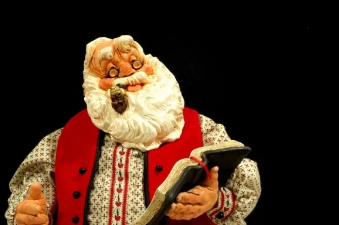 Framed Print : Still life. Simpich Caracter Doll, Santa reading book. Property released Framed Print : Still life. Simpich Caracter Doll, Santa reading book. Property released