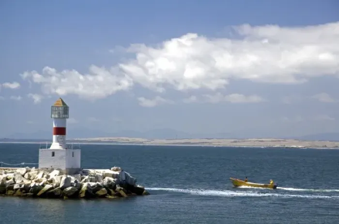 Framed Print : Lighthouse and motor boat off the coast of Concon in the Valparaiso Region of Chile