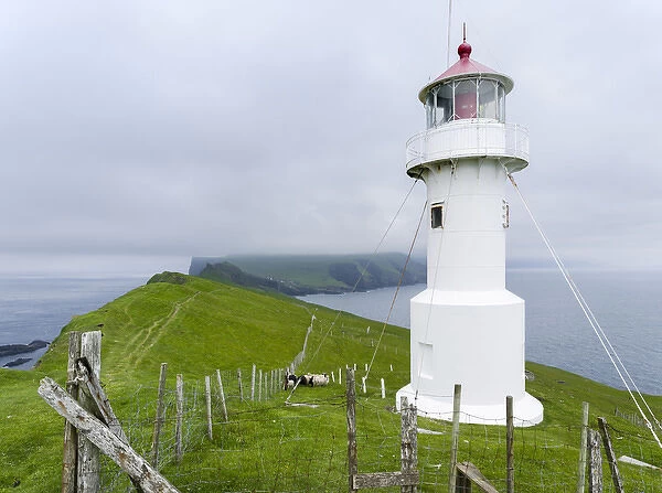 The lighthouse on Mykinesholmur. The island Mykines, part of the Faroe Islands in