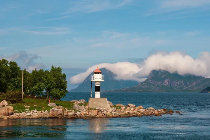 Framed Print : A lighthouse perches on a rocky promontory and reflects on Holandsfjorden. Svartisen, Norway Framed Print : A lighthouse perches on a rocky promontory and reflects on Holandsfjorden. Svartisen, Norway