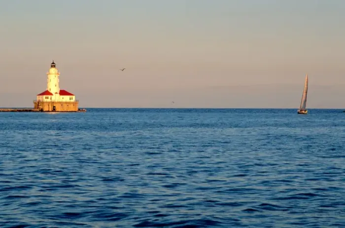 Framed Print : A lighthouse and sailboat on Lake Michigan, Chicago, Illinois. lighthouse