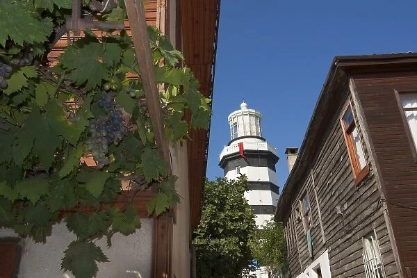 Lighthouse of Sile as seen behind old wooden houses, Istanbul, Turkey